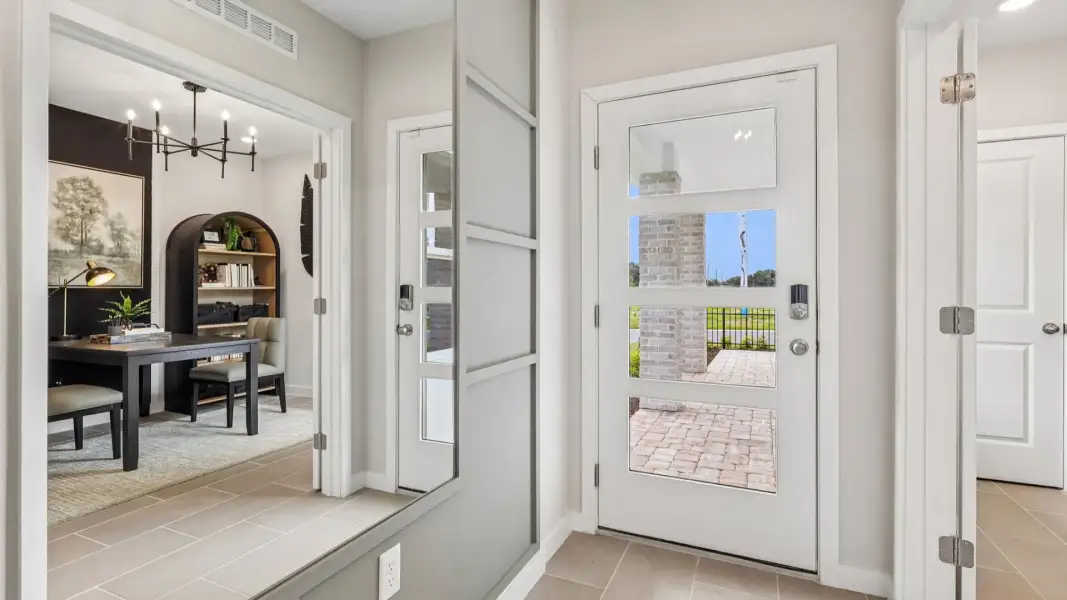 Flagler Floor Plan in Modern Elevation Door with a flex space staged as a study to the left of entry
