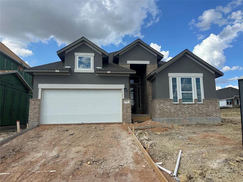 A newly constructed residence combines brick and stucco for an appealing facade. A newly constructed residence combines brick and stucco for an appealing facade.