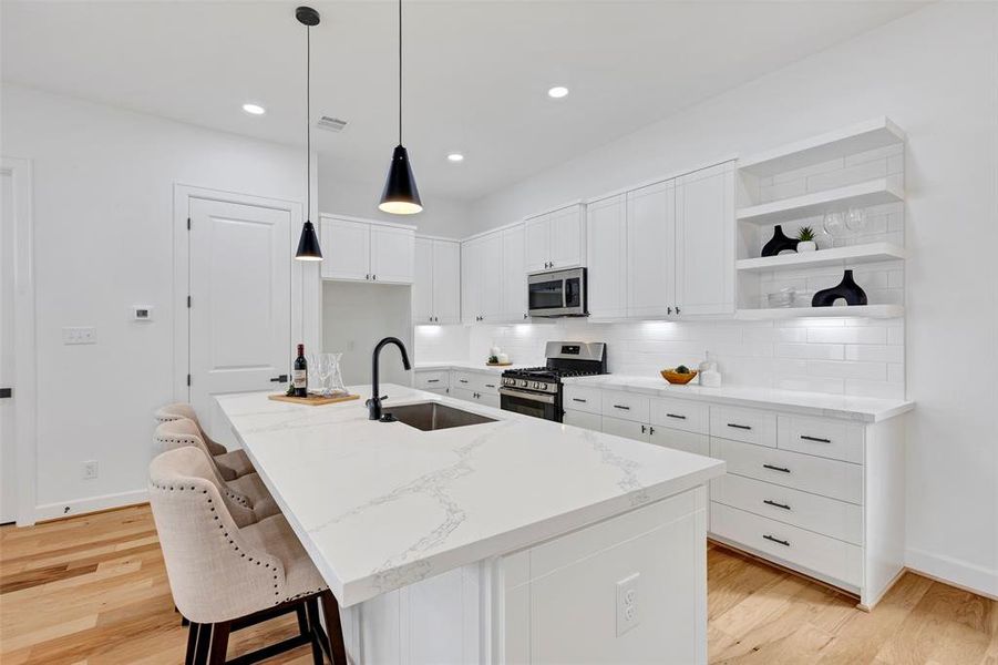 Elegant marble countertops creating a bright, airy atmosphere in the kitchen. (Model Unit 9424C)