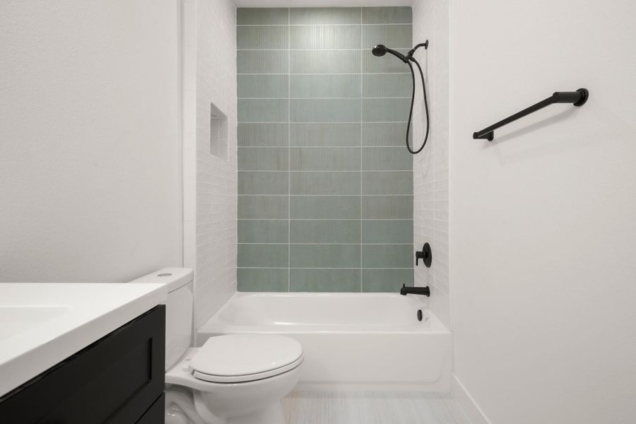 Bathroom featuring vanity and washtub / shower combination