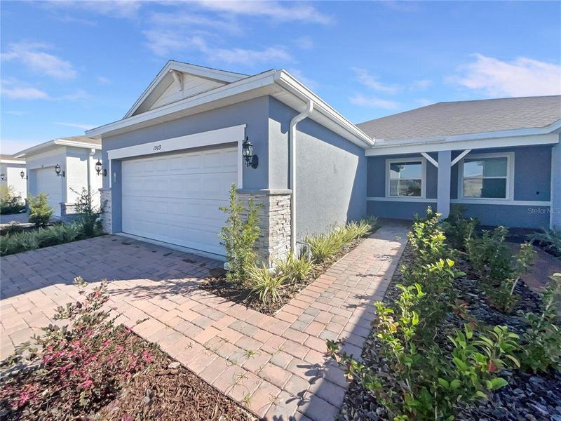 Front exterior of a new home in , Kissimmee, FL, highlighting curb appeal (Image 26).