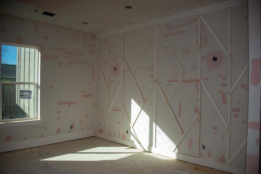 Highlighted dining room with wall paneling for a sophisticated touch