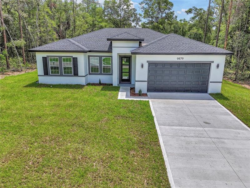 Front exterior of a new home in , Dunnellon, FL, highlighting curb appeal (Image 17).