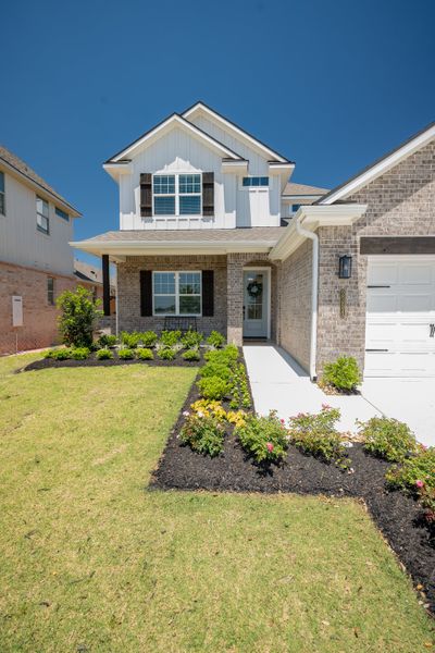 Front exterior of a new home in Greens Prairie Reserve, College Station, TX, highlighting curb appeal (Image 22).