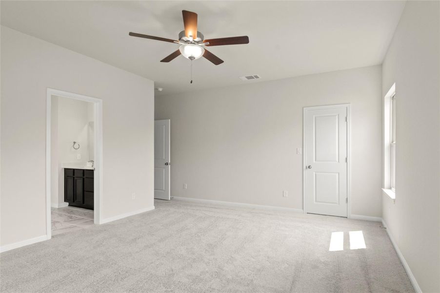 Unfurnished room featuring ceiling fan and light carpet