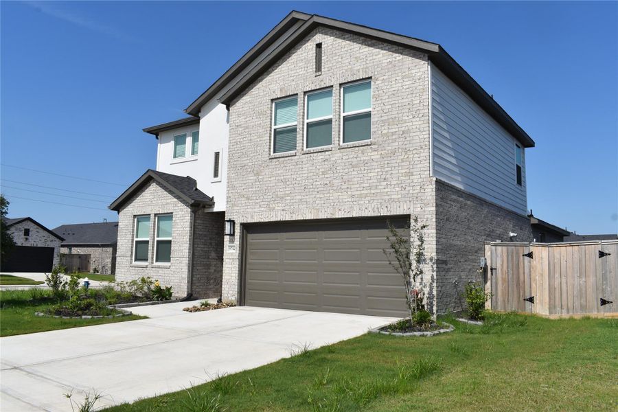 Front exterior of a new home in Bridge Creek 45s and 50s, Cypress, TX, highlighting curb appeal (Image 2). Front exterior of a new home in Bridge Creek 45s and 50s, Cypress, TX, highlighting curb appeal (Image 2).