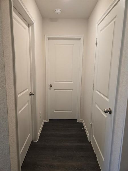 Hallway with dark hardwood / wood-style floors