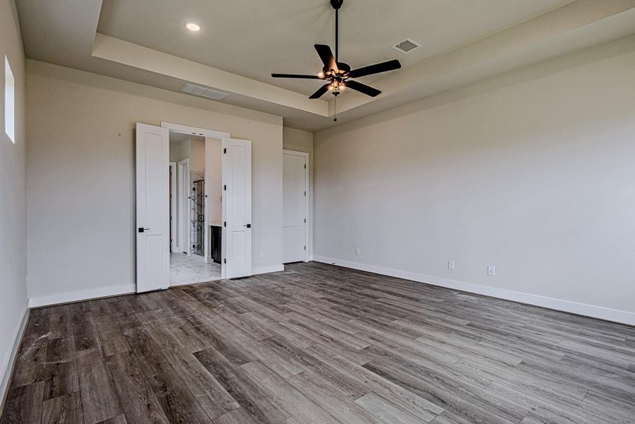 Private primary retreat featuring tray ceilings and generous floor space Private primary retreat featuring tray ceilings and generous floor space
