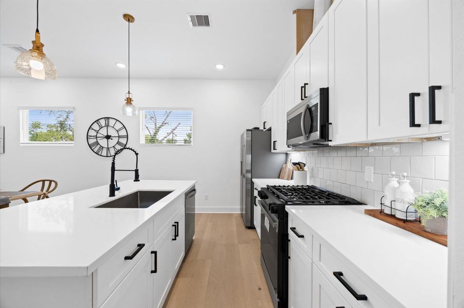 A spacious kitchen island serves as the focal point, offering ample counter space for cooking and entertaining. A spacious kitchen island serves as the focal point, offering ample counter space for cooking and entertaining.