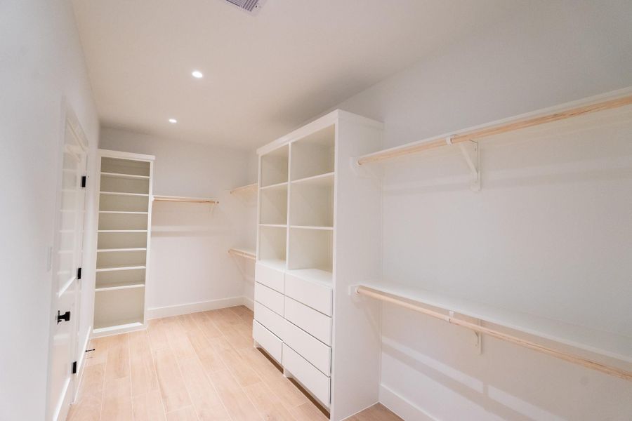 Huge custom walk in closet with access to the laurndy room