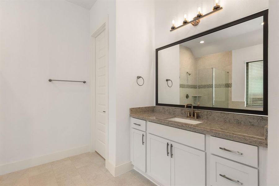 Experience the luxury of convenience with double sinks in the en suite bathroom, offering ample space and a touch of elegance to your daily routine.