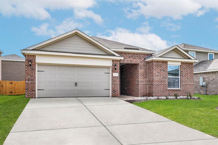 Ranch-style house featuring a front lawn and a garage