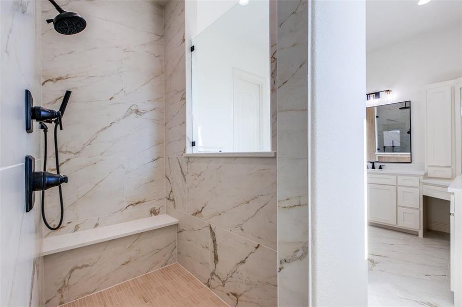 Bathroom featuring vanity and a tile shower