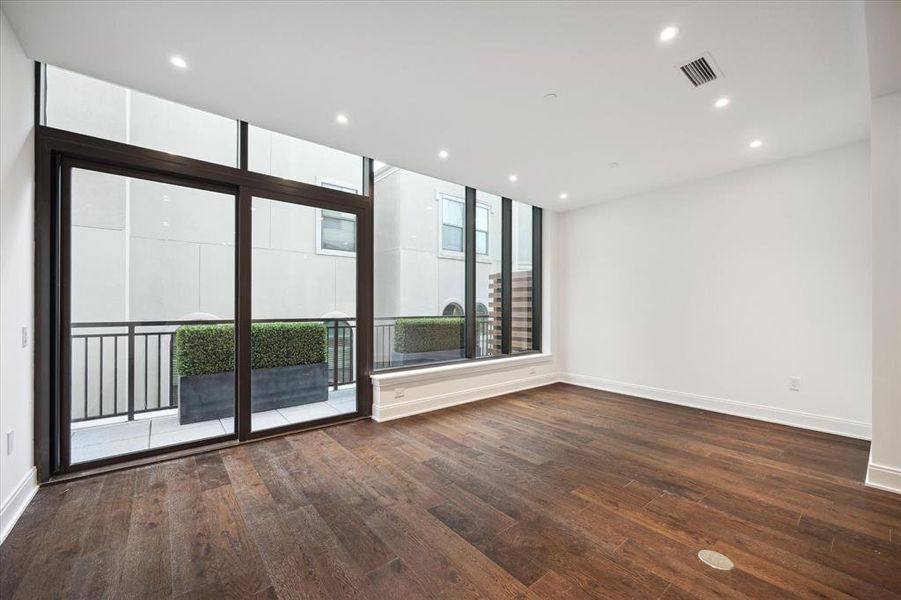 Living/Dining space with large floor-to-ceiling windows & hurricane rated glass doors leading to the terrace. This home is move-in ready, awaiting your personalization.