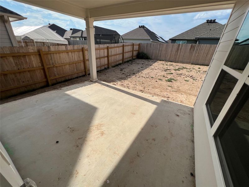 Fenced backyard featuring a patio and a residential view Fenced backyard featuring a patio and a residential view