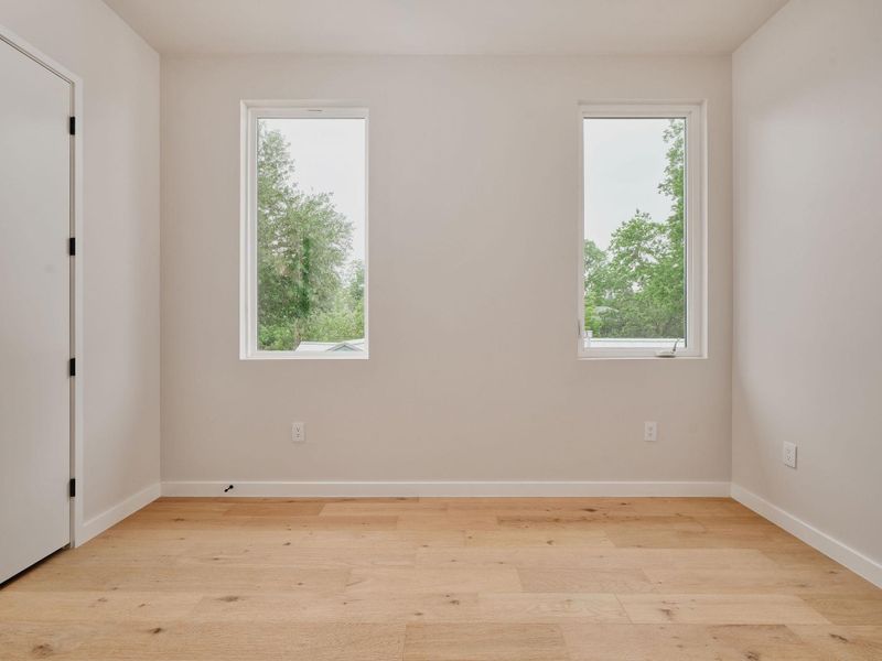 Light wood-finish flooring complements the neutral wall tones