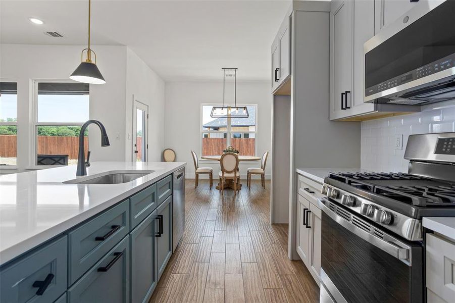 Kitchen featuring stainless steel appliances, sink, plenty of natural light, and backsplash