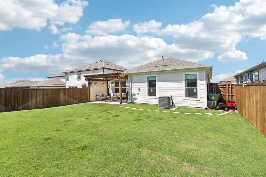 Rear view of house featuring a patio, a fenced backyard, a pergola, and roof with shingles Rear view of house featuring a patio, a fenced backyard, a pergola, and roof with shingles