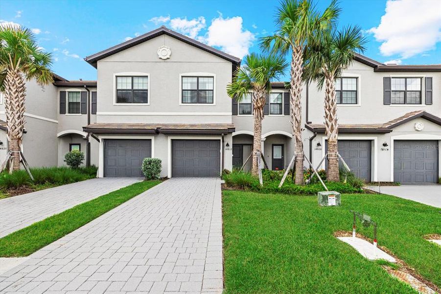 Front exterior of a new home in , Lakewood Ranch, FL, highlighting curb appeal (Image 1).