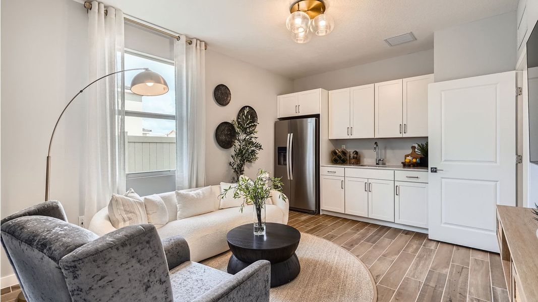 Representative furnished interior of a home built from the Grandcourt by D.R. Horton in Parker Pointe, Homestead (Image 8).