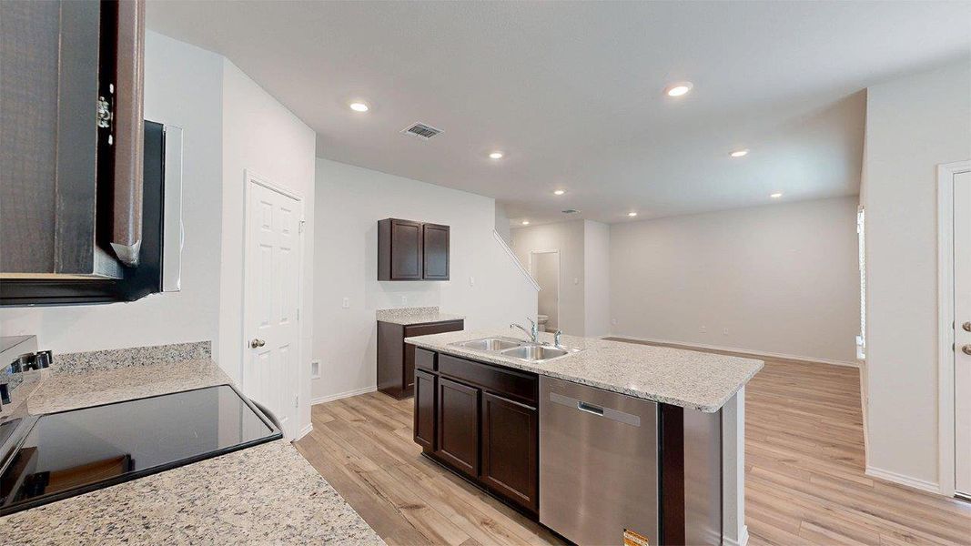 Kitchen featuring dishwasher, electric range, light wood-style flooring, light stone countertops, and recessed lighting Kitchen featuring dishwasher, electric range, light wood-style flooring, light stone countertops, and recessed lighting