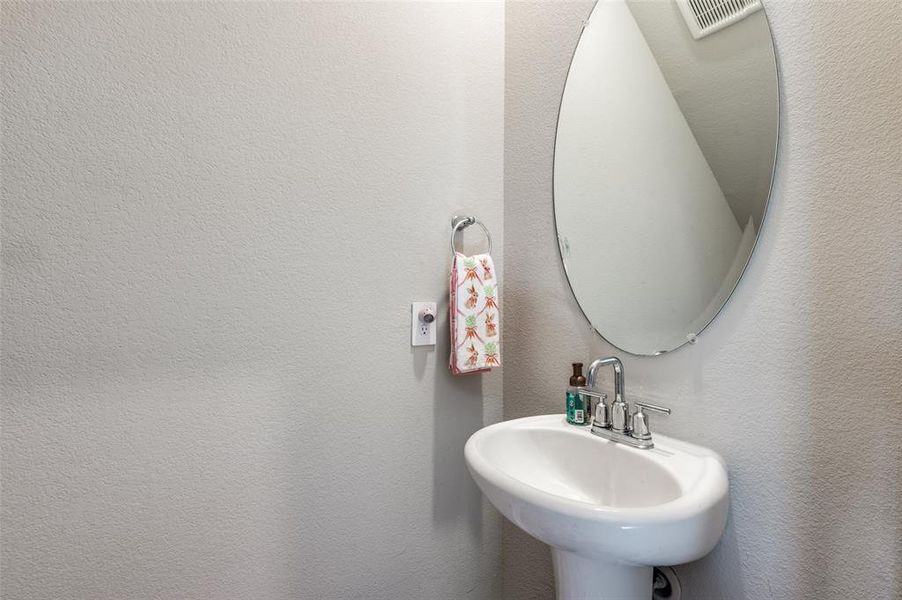 Bathroom with a sink and a textured wall