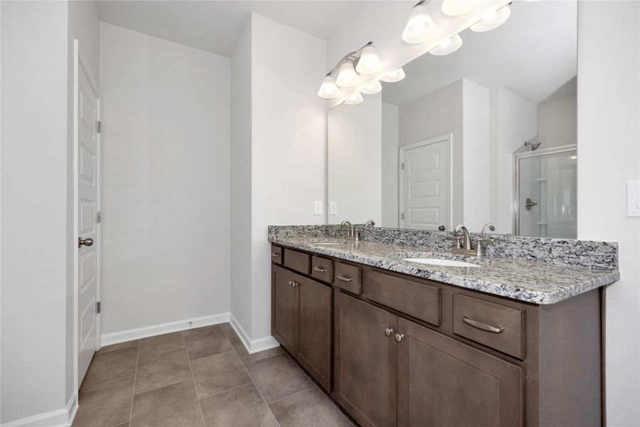 The Harrington- Primary Bath with dual sinks. Sample image for illustration; upgrades, options, and colors may vary. The Harrington- Primary Bath with dual sinks. Sample image for illustration; upgrades, options, and colors may vary.