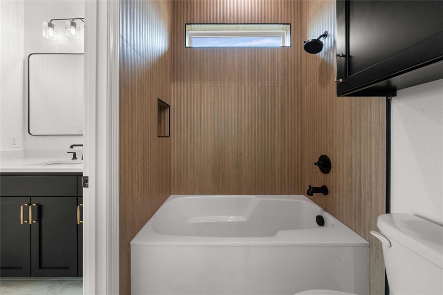A well-appointed bathroom with a sleek soaking tub and modern fixtures awaits. A well-appointed bathroom with a sleek soaking tub and modern fixtures awaits.
