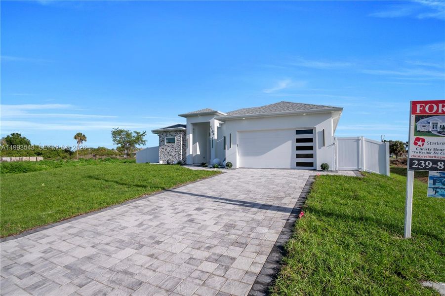 Front exterior of a new home in , Lehigh Acres, FL, highlighting curb appeal (Image 23).