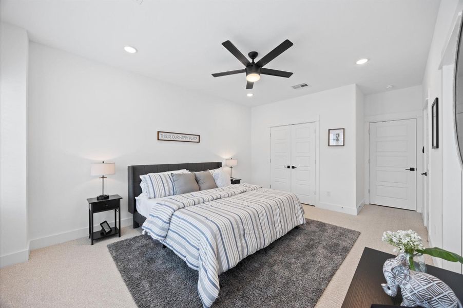 Very spacious primary bedroom located on the 2nd floor. The high ceilings, with recessed lighting, are prewired and blocked for ceiling fans (not included).