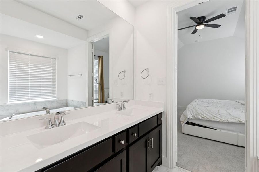 Bathroom featuring double vanity and a ceiling fan Bathroom featuring double vanity and a ceiling fan