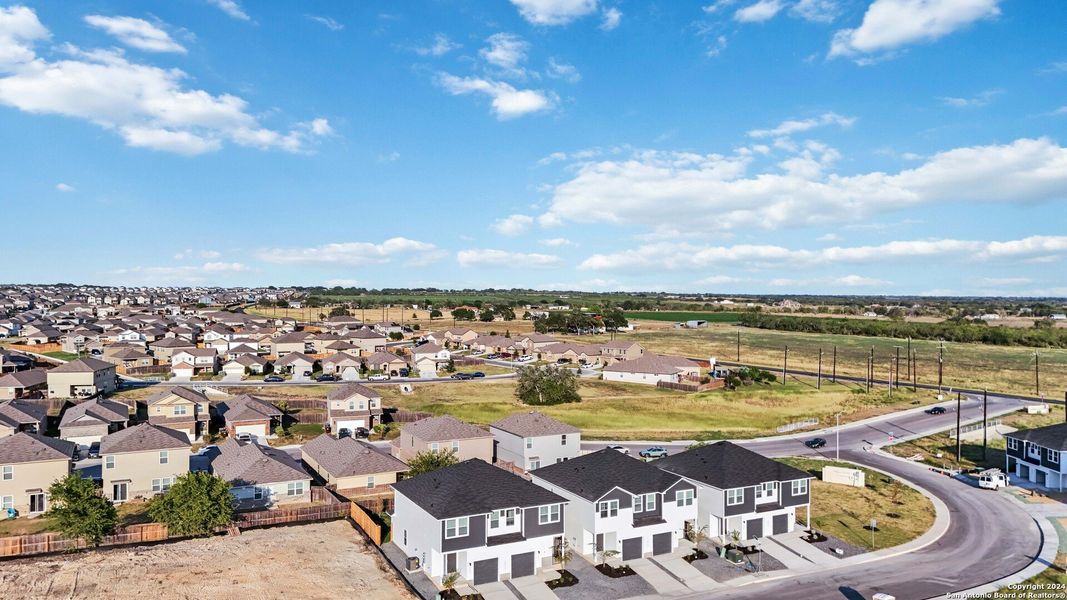 Aerial view of the Abbott Run community in St. Hedwig, TX, showing layout and nearby surroundings (Image 1).