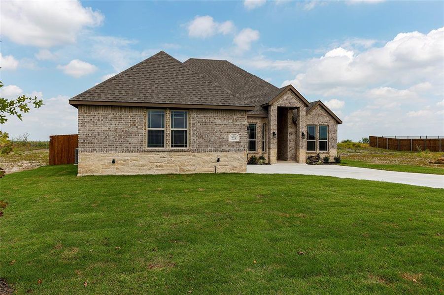 Front exterior of a new home in , Venus, TX, highlighting curb appeal (Image 2).
