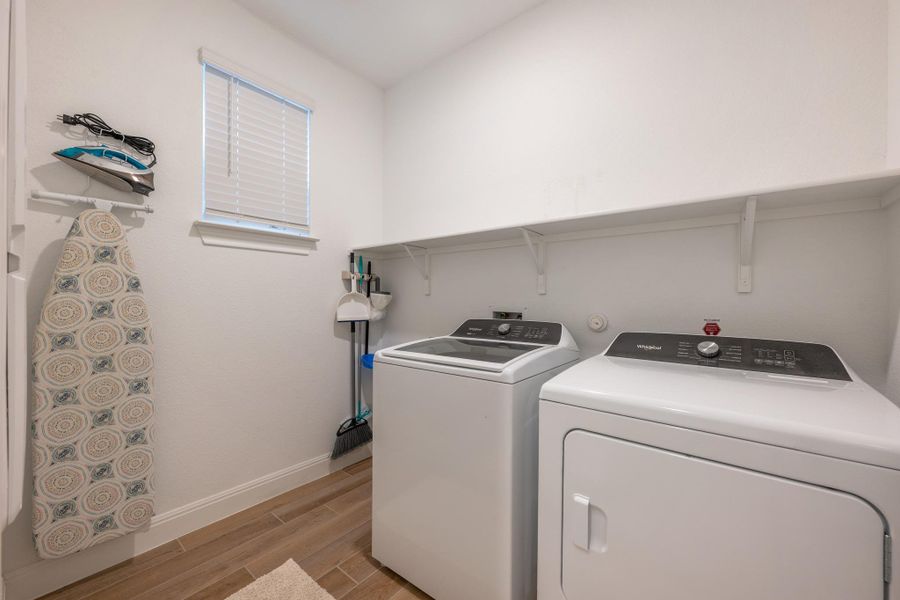 A well-appointed laundry area offers convenient household utility with ample shelving. A well-appointed laundry area offers convenient household utility with ample shelving.