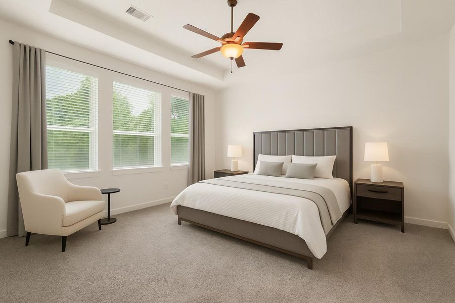 The primary bedroom welcomes you with bright natural light, high tray ceilings, a ceiling fan, and the perfect view of the serene yard. It sits at the back of the home offering additional privacy and easily fits a king size bed plus furniture! *This room has been virtually staged The primary bedroom welcomes you with bright natural light, high tray ceilings, a ceiling fan, and the perfect view of the serene yard. It sits at the back of the home offering additional privacy and easily fits a king size bed plus furniture! *This room has been virtually staged