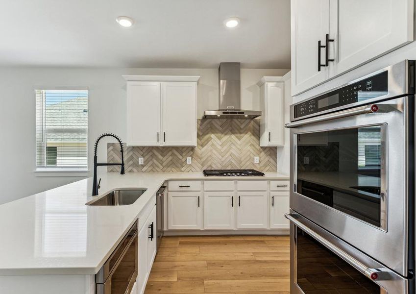 The kitchen has gorgeous white wood cabinetry.