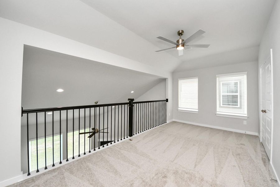 Ascend to relaxation in this fantastic game room! Ideal for both casual gatherings and adult gaming, it boasts plush carpet, lofty ceilings, custom paint, and ample windows for abundant natural light. Sample photo of completed home with similar floor plan. Actual colors and selections may vary. Ascend to relaxation in this fantastic game room! Ideal for both casual gatherings and adult gaming, it boasts plush carpet, lofty ceilings, custom paint, and ample windows for abundant natural light. Sample photo of completed home with similar floor plan. Actual colors and selections may vary.