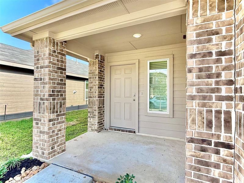 Welcoming front porch with space for packages. Seasonal décor and the handmade wreath are lovingly created by the tenant. [Virtual Staging]