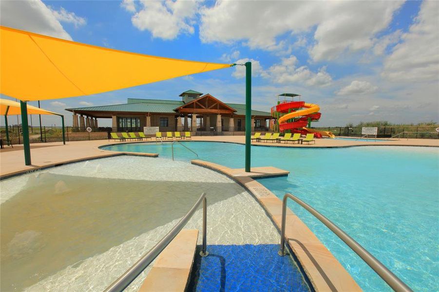 View of pool with a water slide and a patio