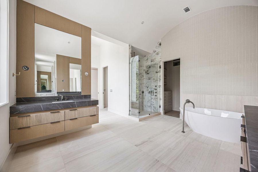 Another view of the Primary Bathroom which also offers incredible tile work. The ceiling in this room features a soft, vaulted form with a gentle barrel-like curve. Construction as of June 1st, 2026.