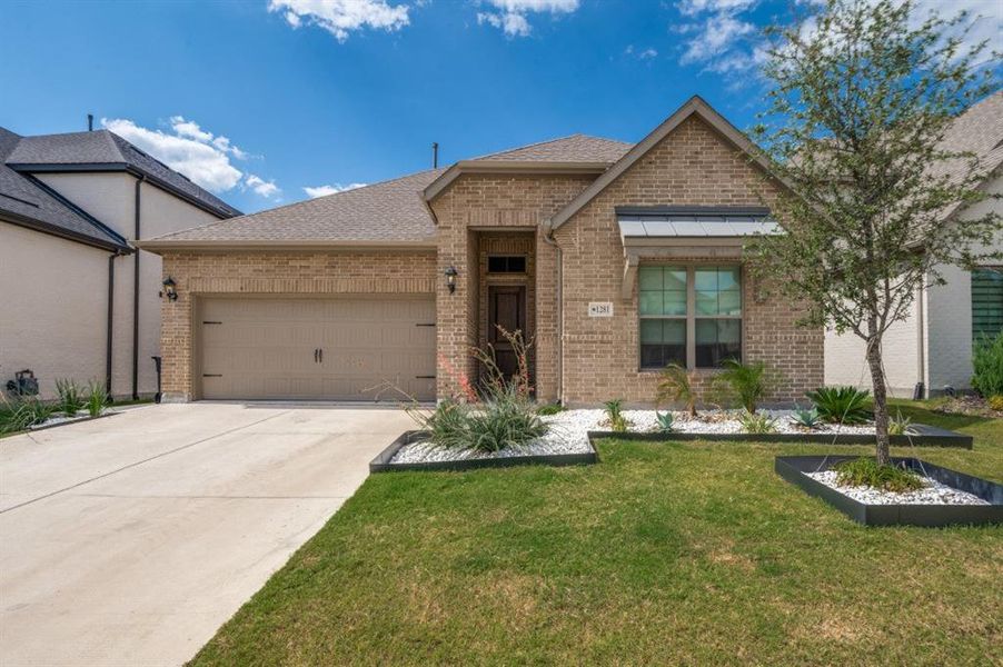 View of front of property with brick siding, roof with shingles, a front lawn, concrete driveway, and an attached garage View of front of property with brick siding, roof with shingles, a front lawn, concrete driveway, and an attached garage