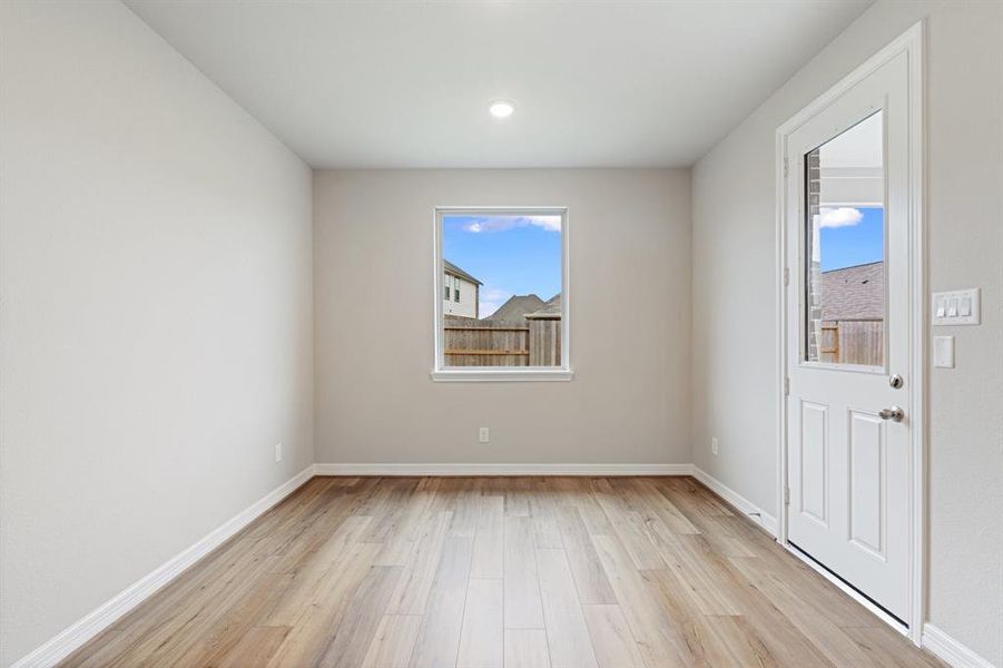 With an abundance of natural light streaming through the windows, the breakfast nook is bathed in a sunny glow, creating the perfect atmosphere to enjoy your morning coffee or a family breakfast.