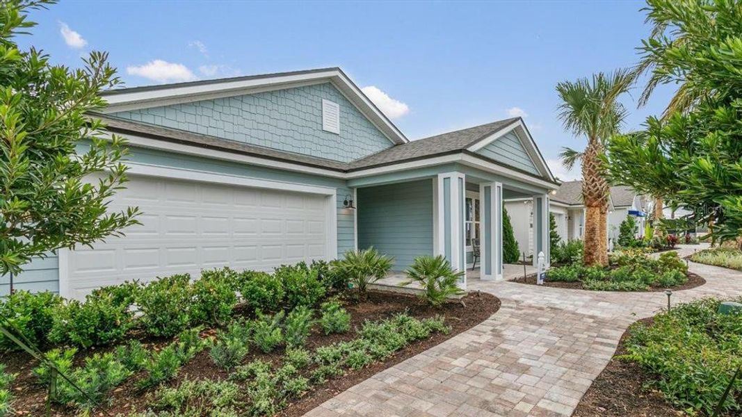 Front exterior of a new home in Sawmill Branch Express, Palm Coast, FL, highlighting curb appeal (Image 23).