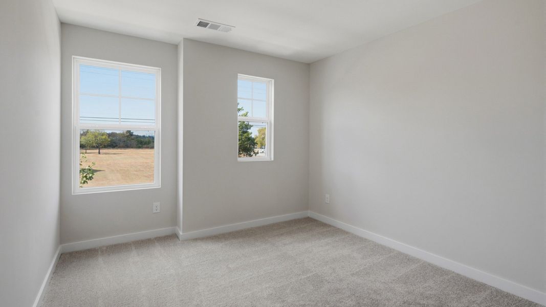 Secondary bedroom with upstairs view of community