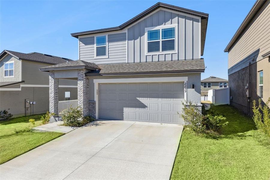 Front exterior of a new home in Hills of Minneola, Minneola, FL, highlighting curb appeal (Image 18).