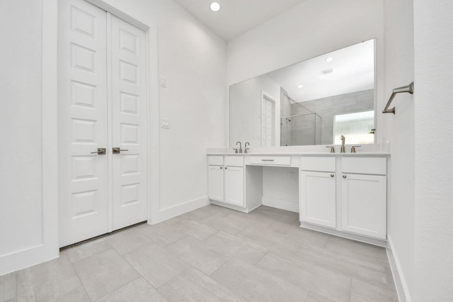 Indulge in a spa-like retreat within the confines of this primary bathroom. Delight in a spacious walk-in shower enveloped in stylish tile surround, unwind in a separate garden tub adorned with custom detailing. Indulge in a spa-like retreat within the confines of this primary bathroom. Delight in a spacious walk-in shower enveloped in stylish tile surround, unwind in a separate garden tub adorned with custom detailing.
