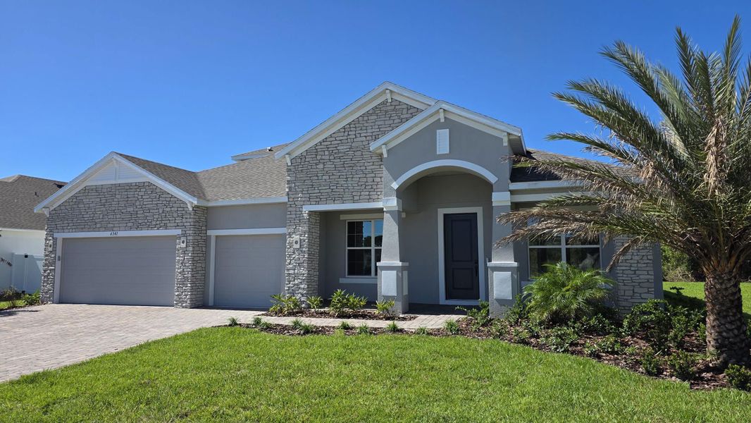 Front exterior of a new home in Island Forest Preserve, Merritt Island, FL, highlighting curb appeal (Image 1).