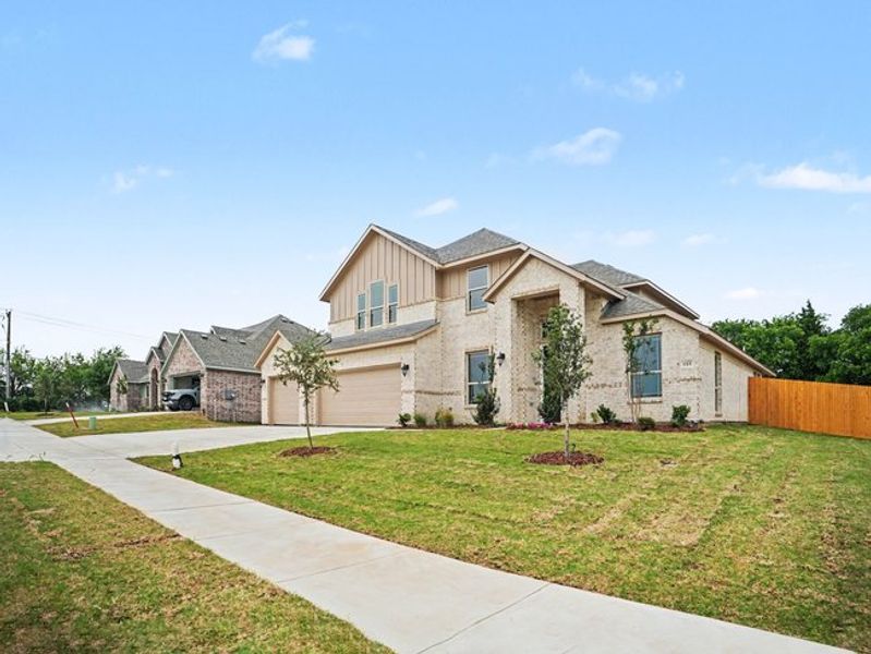 Front exterior of a new home in Cole Crossing Estates, DeSoto, TX, highlighting curb appeal (Image 15).