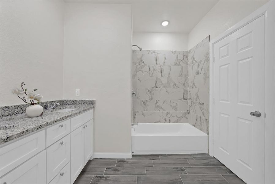 Bathroom featuring vanity and bathtub / shower combination