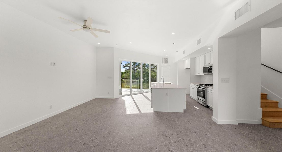 The island kitchen opens to the living level, so the cook is always part of the conversation — ideal for hosting or a quiet night in. Model No. 104 Shown.